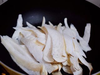 5、孜然杏鲍菇,放入杏鲍菇翻炒至变色，继续翻炒至无水分
