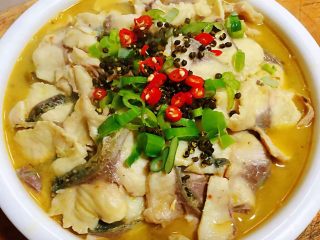 18、酸菜鱼片汤,做好的鱼片摆在酸菜上面在放入葱花、红辣椒、藤椒