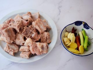 2、红烧排骨,排骨斩成小块洗净，冷水下锅，放入排骨，大火烧开后捞出浮沫再捞出排骨沥干水分备用，姜切片，蒜切片，葱切寸段