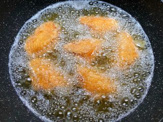 6、香酥鸡翅,热锅放入500毫升油，烧至7成热，把鸡翅一个个放到油锅里，待鸡翅定型再转中小火慢炸。