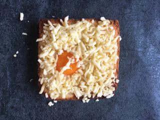 8、早餐+鸡蛋芝士土司面包,将一碗芝士均匀撒在表面，芝士可以多些摆平就好