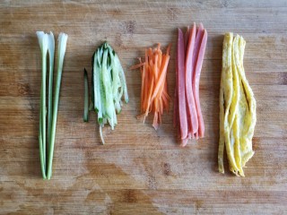 3、五彩豆皮卷——解年腻必备,将蛋皮，方火腿，黄瓜，胡萝卜切丝，香菜用菜杆即可。