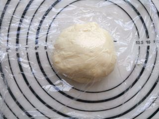 2、培根薯角薄底披萨,揉好的面团盖上保鲜模醒发。