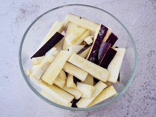 2、鱼香茄条,茄子洗净切成条状，再撒上1茶匙盐抓匀腌制10分钟备用