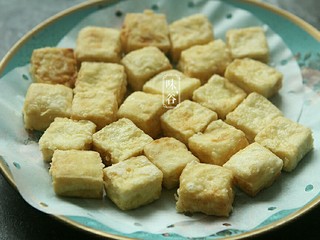 9、蚝油一口豆腐,炸好的豆腐放在吸油纸上，吸油纸用完了我用蒸笼纸垫着 。