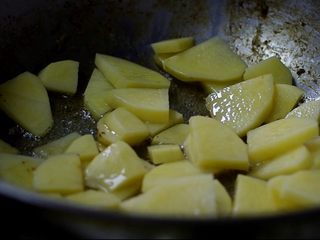 10、茶树菇干锅鸡,放入蒜和土豆，炒香