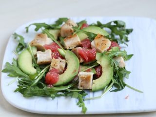 12、芝麻菜西柚鸡肉沙拉,托盘上铺上芝麻菜,摆入牛油果、鸡胸肉,将西柚果肉掰开,点缀在沙拉上。
