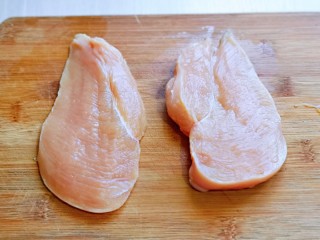 3、手撕鸡胸肉,首先将鸡胸肉洗干净，从中间切开，一切二。