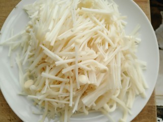 2、金针番茄蛋汤,金针菇切掉头部到切成三段撕开