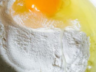 14、鱼香茄饼,面粉中打入一个鸡蛋搅拌均匀再掺入适量清水搅匀做成面糊水