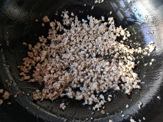 9、干煸芸豆,锅里留底油，倒入肉末，大火炒干肉末的水份，转小火将肉末炒香（可以将肉末炒的稍微干一点，口感会好，也会逼出五花肉里的油脂）。