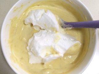 10、香蕉戚风蛋糕,分三次把蛋白加入蛋黄糊内，用刮刀翻拌均匀。