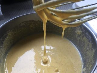 2、软软奶香玉米饼,刚开始加水没感觉的时候，水可以慢慢的加，加到提起打蛋器面糊呈带状流下，流入面糊略有花纹并且能够自行消失，这个状态如图。