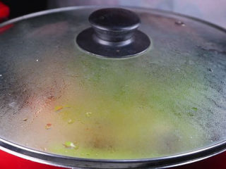 18、往青椒里塞入半斤金针菇,这味道绝了!,调料摊均匀后盖上盖子焖煮。中毒可以打开盖子翻面然后继续盖上盖子焖煮。