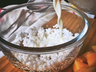 5、港式甜品 木瓜椰奶西米露,将椰奶倒入西米中