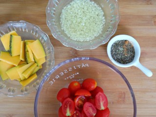 5、混合香草佛卡夏,这个时间可以先预热烤箱220°，把圣女果切成两半，南瓜切成薄片用厨房纸吸干表面水分，大蒜磨成细末放入橄榄油里，所有香草混合一起备用