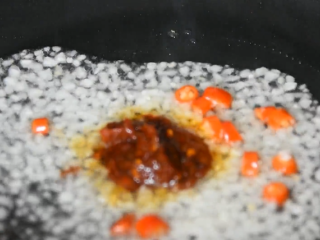 9、这样做的茄盒不用炸,煎烧茄盒少油健康又入,热锅冷油,下蒜末、小米椒、1勺豆瓣酱