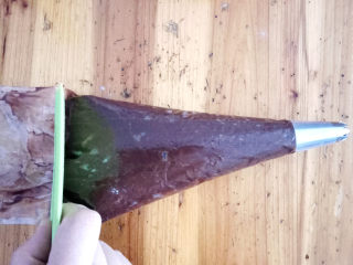 11、巧克力手指泡芙,准备一个裱花袋,装入六齿花嘴,将面糊倒入袋中。