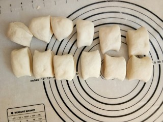 7、萌萌的小猪包,用手掌轻轻压面，把面团里的空气排出，整成长条并切成12等份小面团。