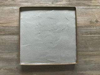 5、黑米戚风蛋糕卷,将混合好的面糊倒入盘内，用刮平稍加刮平，震两下模。