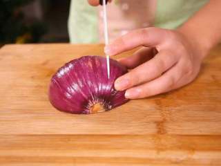 3、法式香橙煎鸭胸 , 洋葱去掉外皮后洗净，洋葱的切面朝下放在砧板上，垂直向下切开。