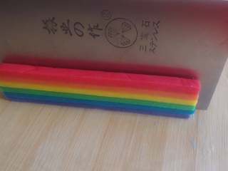 9、彩虹爱心饼干,蛋白+水调匀,用小刷子刷在每一片面皮上,并轻轻按压,使之粘牢。冷藏固定后,就可以取出,根据模具的厚度进行切片。