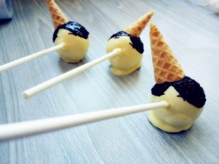 11、皮诺曹棒棒糖蛋糕,用装入剪口裱花袋融化的黑巧克力画出头发和眉毛，嘴巴轮廓。