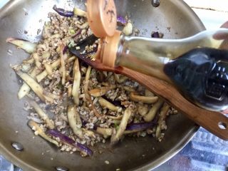 10、肉末茄子粉丝煲,加入一勺老抽翻炒上色