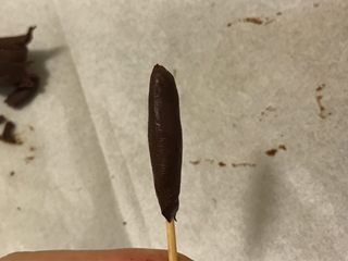 6、手工巧克力玫瑰花,取出刚才压平的巧克力片裹在牙签上当做花芯。