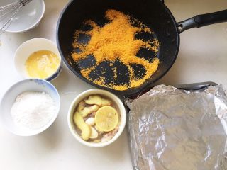 9、几乎无油的“炸”猪排,蛋黄打成蛋液，加点黑胡椒粉装在碗里。面粉也装碗里。面包糠准备好。烤盘上铺上锡纸。