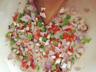 1、小芽早餐-意式早餐鸡蛋杯 ,中火，锅底刷一层橄榄油，放入培根、青椒、红椒、蘑菇、洋葱、培根煸炒，稍稍有点变色后加入盐和黑胡椒粉