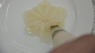 6、清汤鱼芙蓉,把鱼茸装入裱花袋在小盘中挤出第一层花瓣,花型可以自己选择,圆形,五瓣、六瓣都行