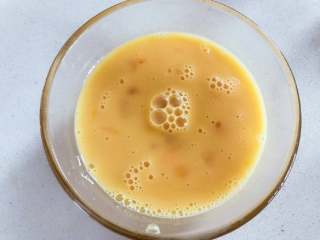 2、宝宝辅食：什锦咸味早餐面包玛芬，简单营养又美味！18M+,准备一个大碗，打入鸡蛋，加少许盐、倒入奶，用打蛋器搅拌均匀备用……