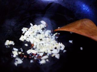 5、荷兰豆海鲜豆芽小炒,陶瓷炒锅烧热后倒入花生油烧至六成热时，爆香花椒和大蒜末。