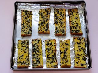 8、椰香黑芝麻吐司条,依次做完的吐司条，烤盘铺上锡纸，抹一层薄薄的油防粘，并把吐司条间隔距离。