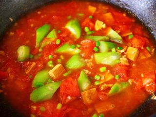 16、番茄香干烩丝瓜,撒上剩下的蒜苔小丁。