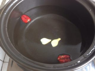 6、黄豆猪皮汤,汤锅里加水，放入姜片和红枣。