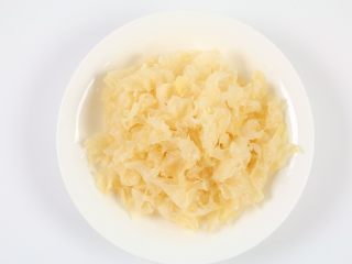3、银耳木瓜糖水,泡发好的银耳撕去蒂，清洗干净后撕成小块。