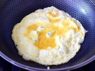 5、海鲜菇鸡蛋汤,锅中倒入10克花生油烧热后,打入鸡蛋液炒熟盛出。