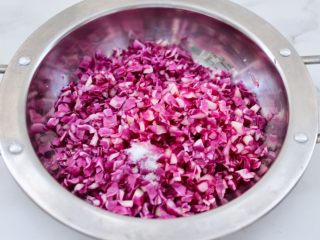2、紫甘蓝鸡肉馅饼,紫甘蓝切碎后,加入适量的盐和几滴新鲜柠檬汁腌制10分钟。
