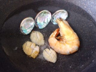 6、鲍鱼对虾香菇菠菜面,另起锅倒入适量的清水，放一克盐和料酒，把鲍鱼和对虾放入锅中，把鲍鱼壳也放到锅里煮一下，留着最后成品拍照用。