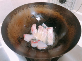 9、红烧鱼块,放入鱼块煎至金黄。