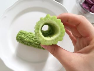 3、紫薯南瓜苦瓜圈,将苦瓜洗净，切去两头，从中间切成两段，去掉苦瓜瓤