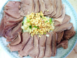 11、凉拌猪舌,将生姜末大蒜末放入盘子中间。将搭好的调料淋在盘子中间。