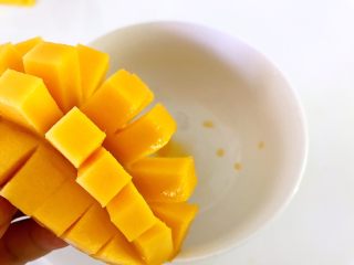 9、芒果西米露,切一半，划十字花刀，取出果肉。