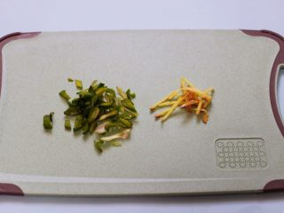 3、桃花虾爆韭菜,葱姜用刀切成丝。