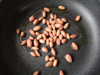 8、家庭版自制烤鱼,热锅凉油下花生米小火翻炒。