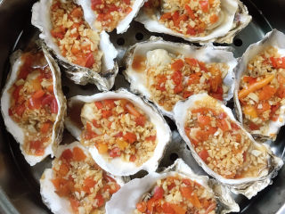 9、蒜蓉剁椒蒸生蚝,将蒜蓉辣椒酱铺在生蚝上面