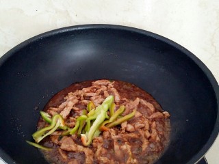 18、土豆酱肉丝卷饼,盖上锅盖中火烧制汤汁浓厚，放入青椒丝，撒上盐1克，拌匀出锅。