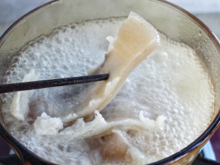 2、洋葱辣椒炒肉皮,大火煮开后改小火，煮至筷子可以轻松插入猪皮后捞出